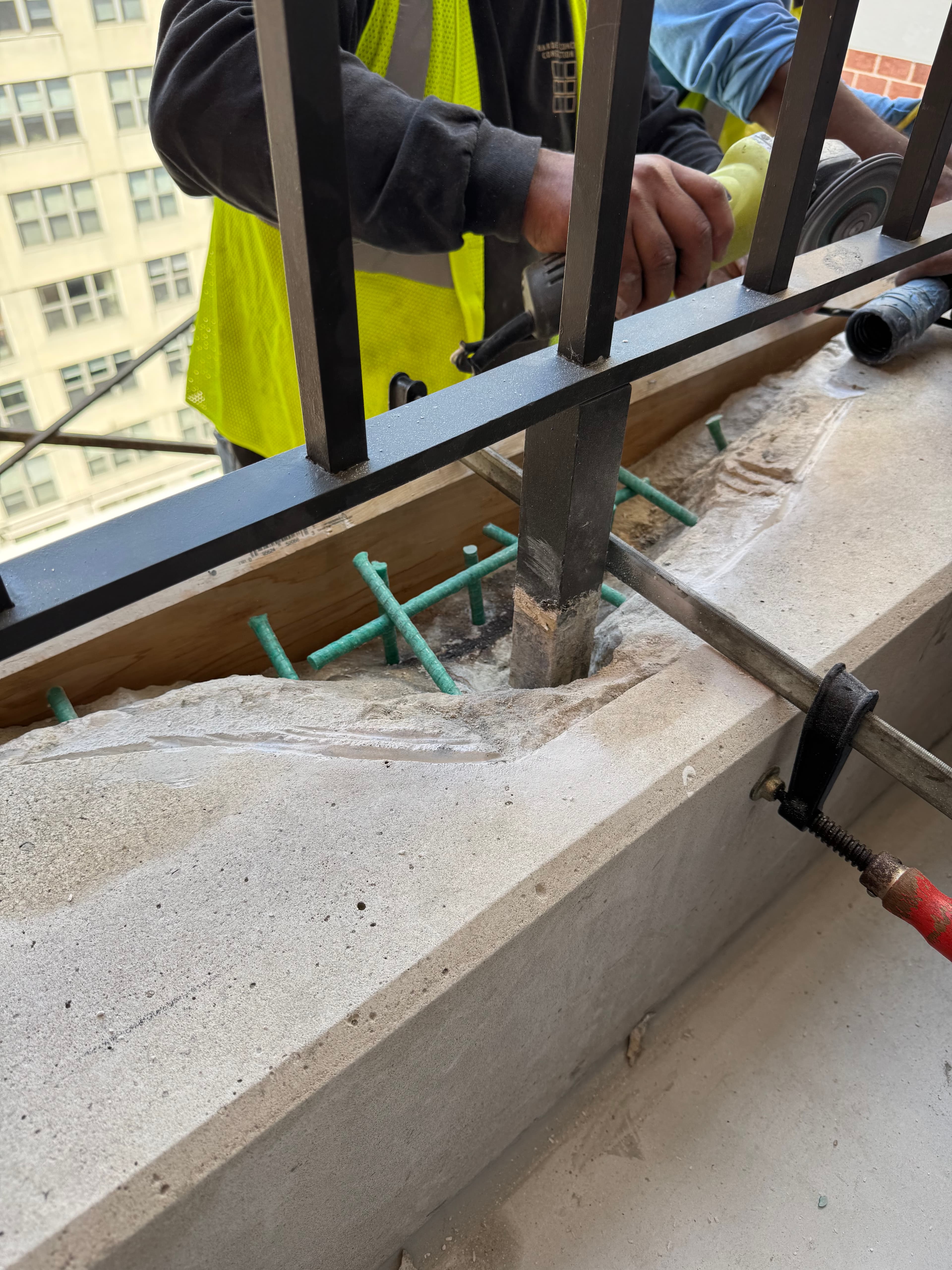 Commercial concrete balcony repair and railing installation in progress in DC by Atlantic Construction