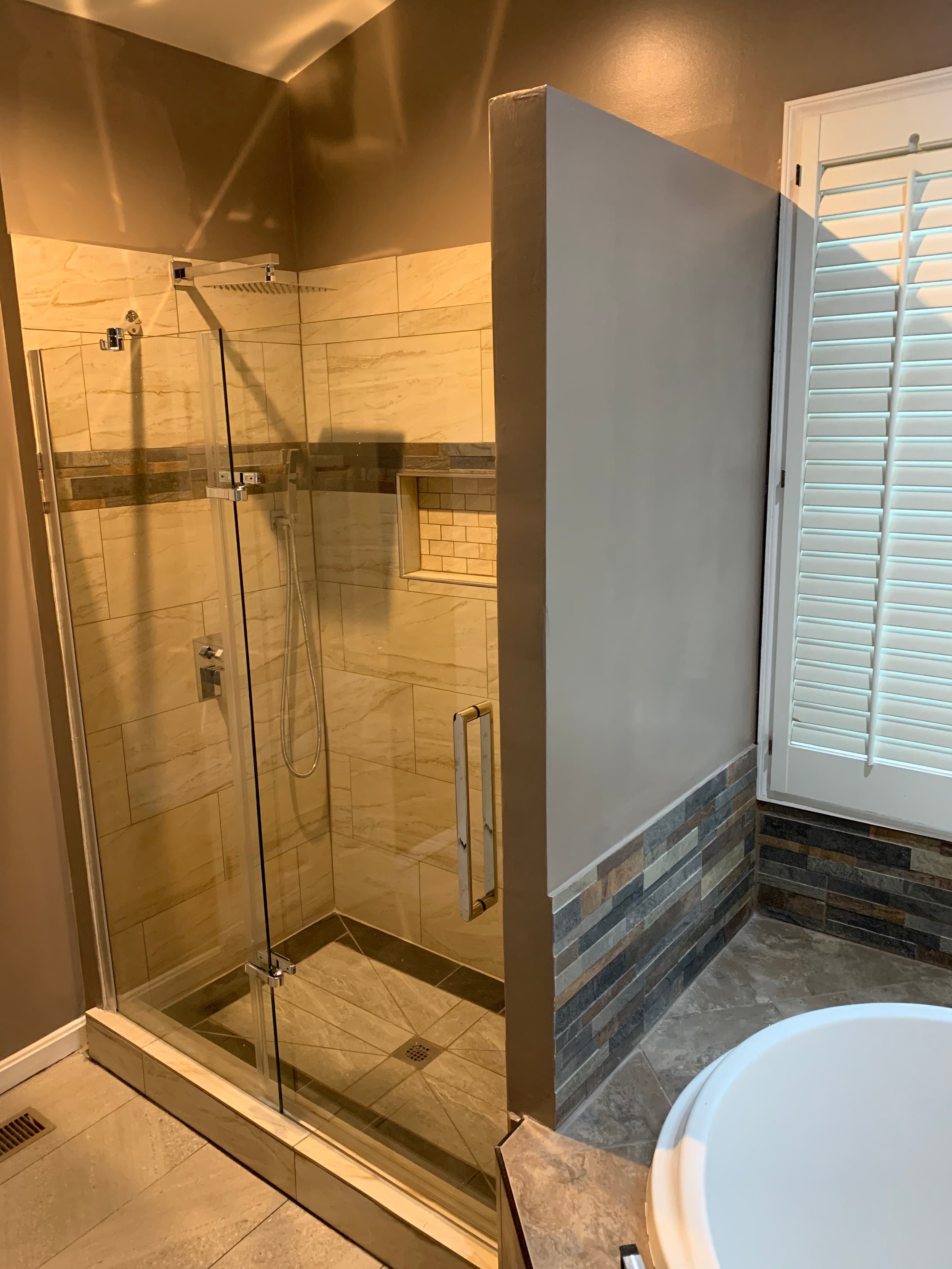 Luxury bathroom with marble tile shower and modern fixtures in Maryland by Atlantic Construction