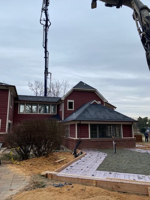 Residential paver walkway installation with crane equipment in Maryland by Atlantic Construction