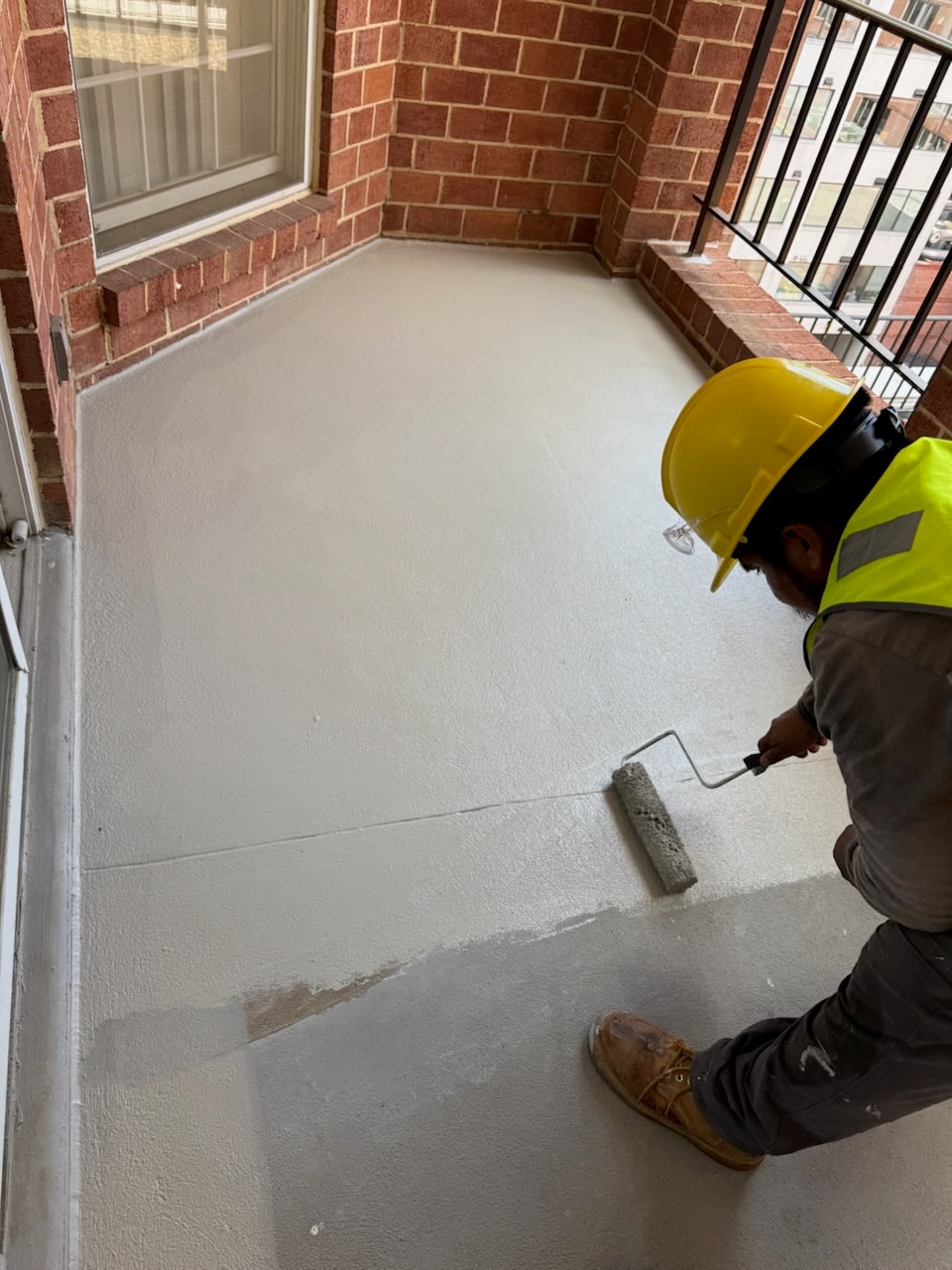 Commercial balcony deck waterproofing application in progress in DC by Atlantic Construction