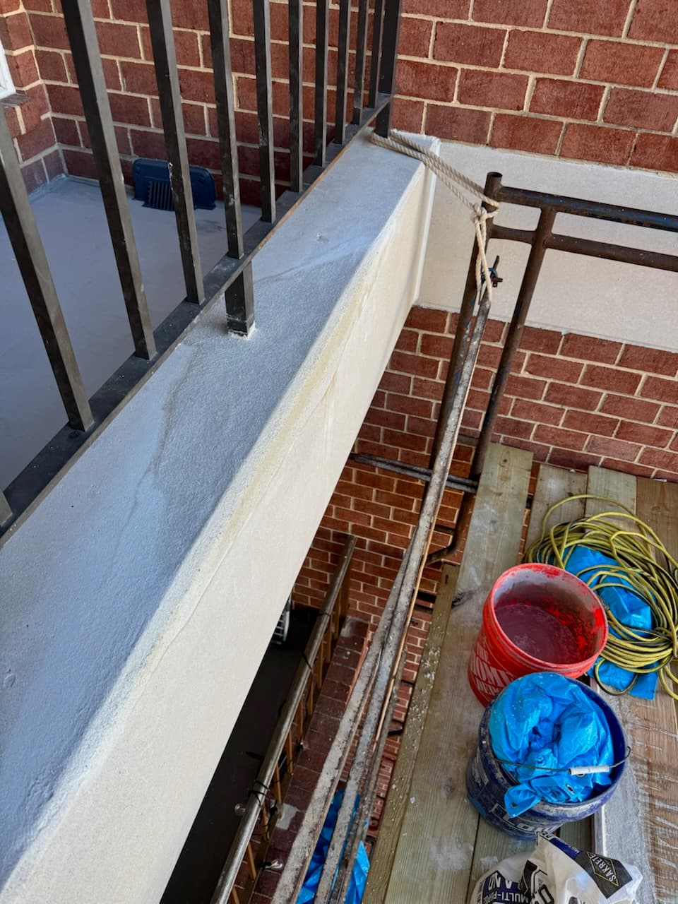 Commercial balcony waterproofing coating application in progress in DC by Atlantic Construction