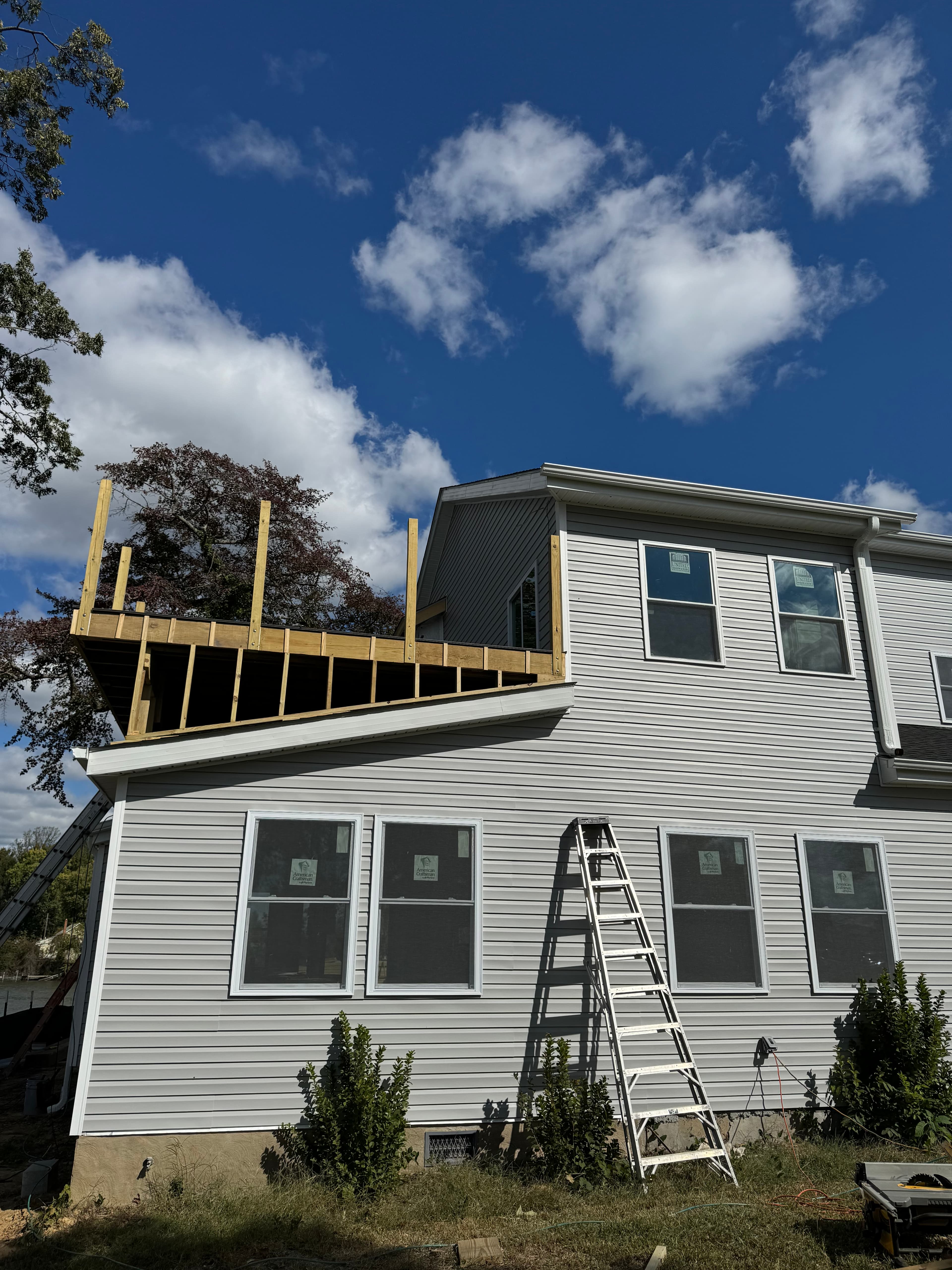 Residential second story addition with fresh framing for upper deck in Maryland by Atlantic Construction